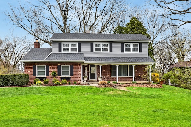 317 Roberts Rd, Inverness, IL 60010 - traditional home with roof with shingles, a porch, a chimney, brick siding, and a front yard