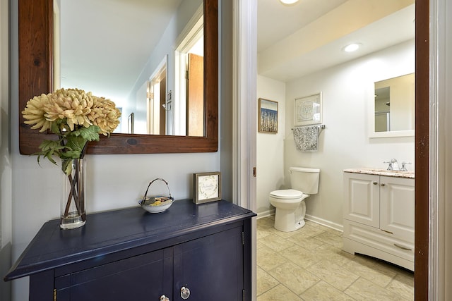 317 Roberts Rd, Inverness, IL 60010 - bathroom with recessed lighting, stone finish floor, toilet, vanity, and baseboards