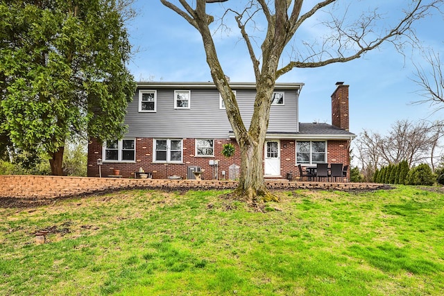 317 Roberts Rd, Inverness, IL 60010 - back of property with a chimney, brick siding, a yard, and a patio