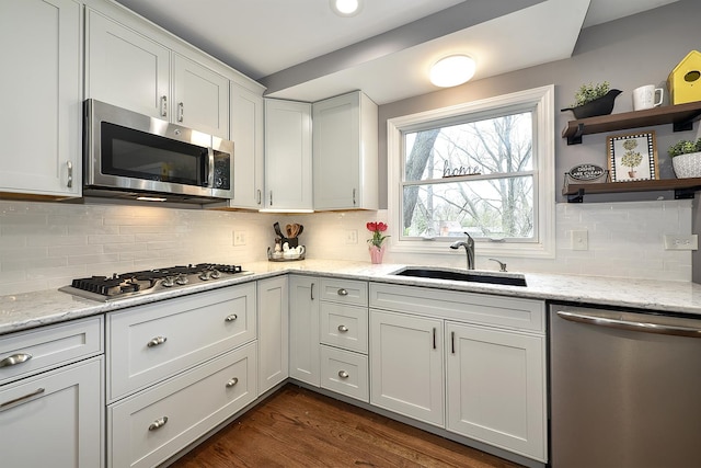 317 Roberts Rd, Inverness, IL 60010 - kitchen featuring white cabinets, stainless steel appliances, dark wood-style floors, a sink, and tasteful backsplash