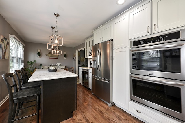 317 Roberts Rd, Inverness, IL 60010 - kitchen featuring stainless steel appliances, a center island, wine cooler, a kitchen bar, and white cabinetry
