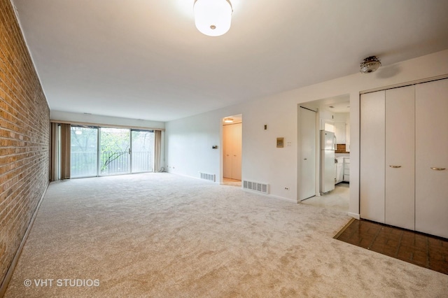 4726 Russet Ln Unit R107, Skokie, IL 60076 - unfurnished living room with carpet floors and brick wall