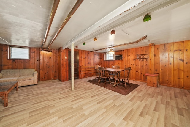 dining room with wood walls and wood finished floors