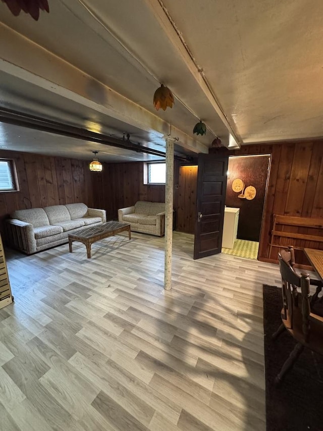 basement featuring wooden walls and wood finished floors