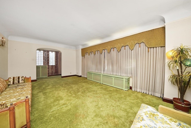 carpeted living room with baseboards and radiator heating unit