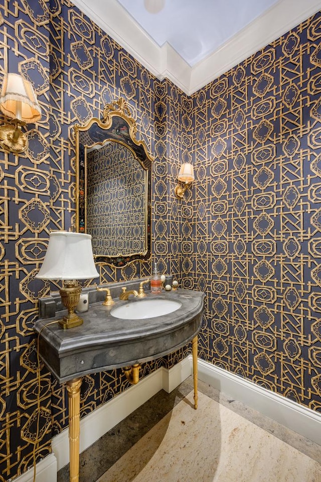 401 W Dickens Ave, Chicago, IL 60614 - bathroom featuring wallpapered walls, baseboards, a sink, and ornamental molding