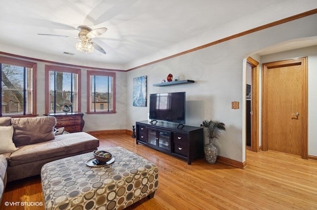 5840 N Saint Louis Ave Unit 2N, Chicago, IL 60659 - living area with visible vents, a ceiling fan, arched walkways, light wood-style floors, and baseboards