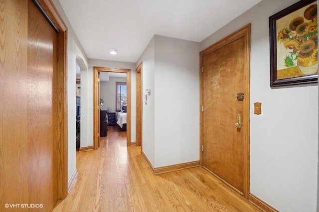 5840 N Saint Louis Ave Unit 2N, Chicago, IL 60659 - corridor featuring baseboards, arched walkways, and light wood-type flooring