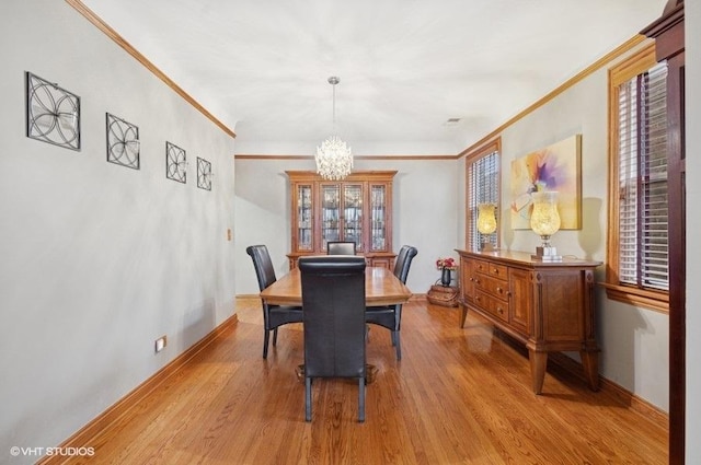5840 N Saint Louis Ave Unit 2N, Chicago, IL 60659 - dining room featuring ornamental molding, a chandelier, and light wood-type flooring