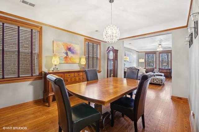 5840 N Saint Louis Ave Unit 2N, Chicago, IL 60659 - dining area with baseboards, ceiling fan with notable chandelier, visible vents, and light wood-type flooring