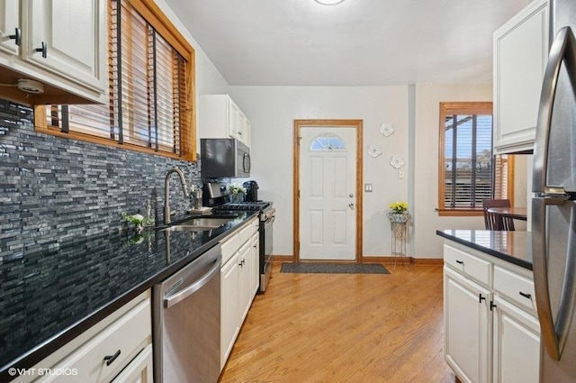 5840 N Saint Louis Ave Unit 2N, Chicago, IL 60659 - kitchen with tasteful backsplash, a sink, light wood-type flooring, white cabinets, and appliances with stainless steel finishes