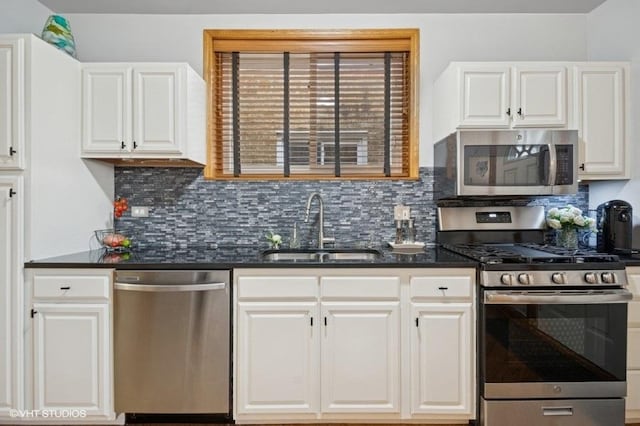 5840 N Saint Louis Ave Unit 2N, Chicago, IL 60659 - kitchen with decorative backsplash, appliances with stainless steel finishes, a sink, and white cabinetry