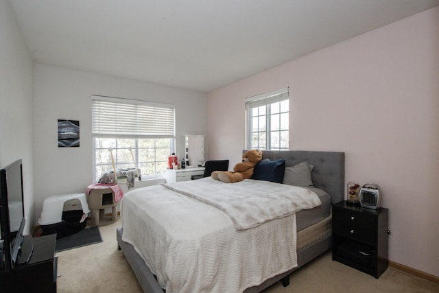 bedroom featuring light carpet