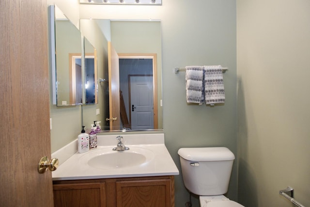 half bathroom featuring toilet and vanity