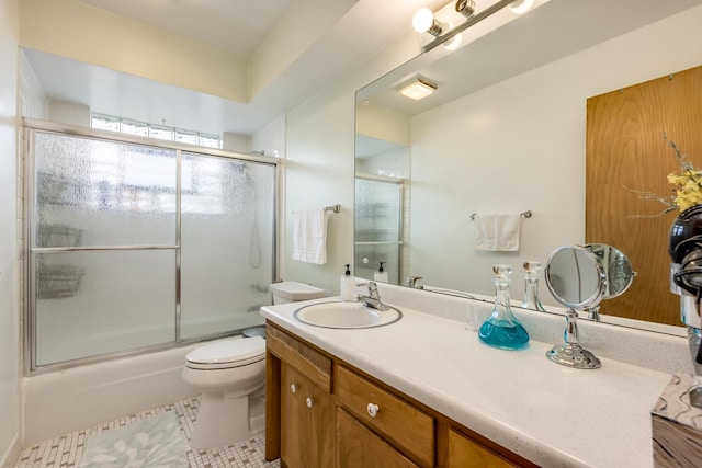 1291 Fargo Ave, Des Plaines, IL 60018 - full bathroom featuring vanity, toilet, tile patterned flooring, and combined bath / shower with glass door