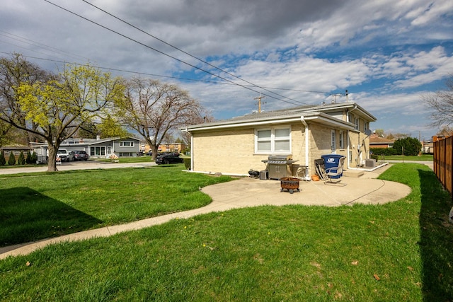 1291 Fargo Ave, Des Plaines, IL 60018 - rear view of property featuring a fire pit, a patio area, a lawn, and brick siding