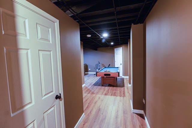 hall featuring wood finished floors and baseboards