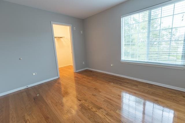 empty room with plenty of natural light and baseboards