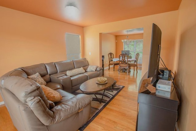 living area with light wood-style floors and baseboards