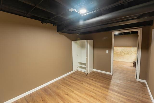 finished basement featuring light wood-style floors and baseboards