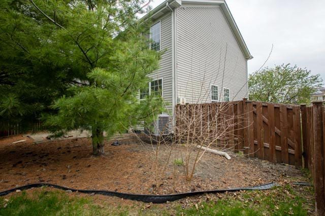 view of property exterior featuring fence and cooling unit