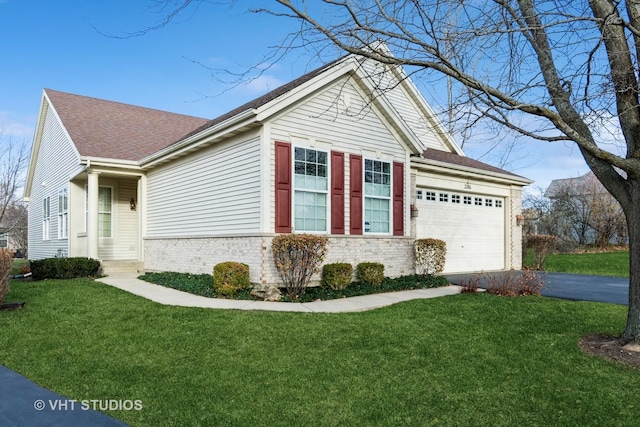 view of property exterior featuring a yard, roof with shingles, driveway, brick siding, and a garage