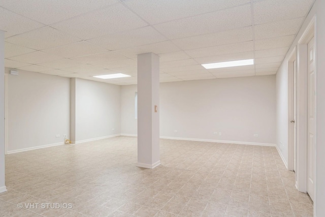 finished basement with a drop ceiling and baseboards