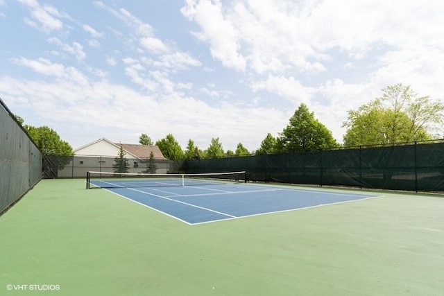 view of sport court featuring fence