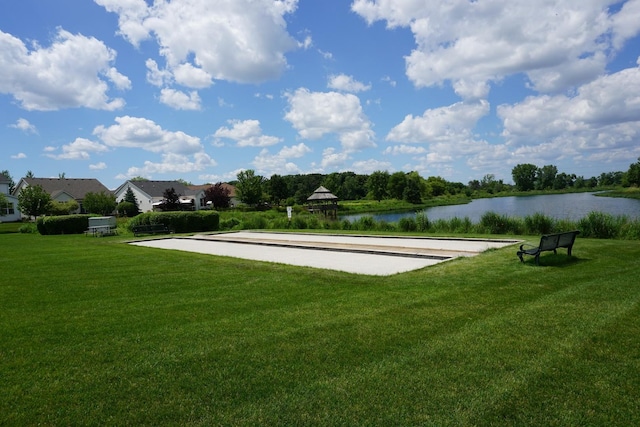 view of community featuring a yard and a water view