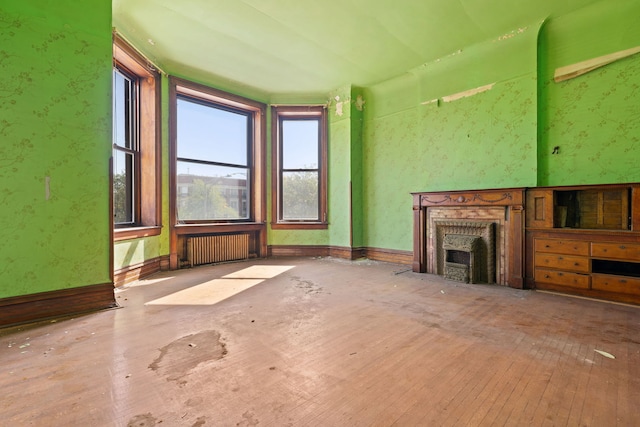 3936 S King Dr, Chicago, IL 60653 - unfurnished living room featuring a fireplace, radiator heating unit, and hardwood / wood-style floors