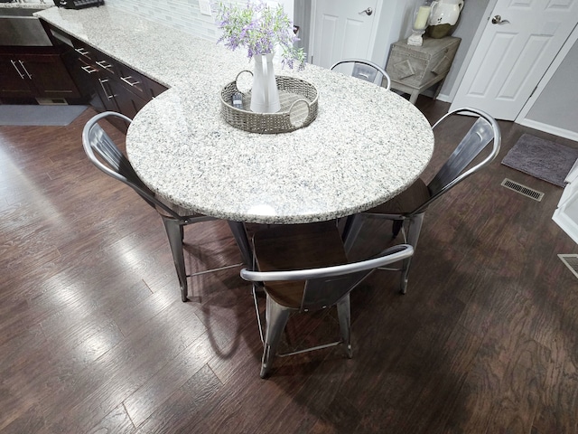 dining space with visible vents and dark wood finished floors