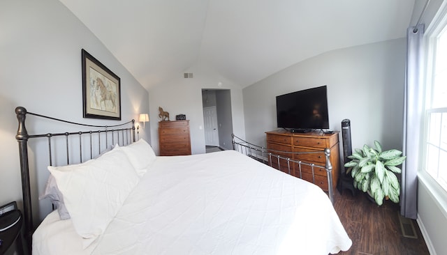 bedroom featuring dark wood-style floors, visible vents, and lofted ceiling