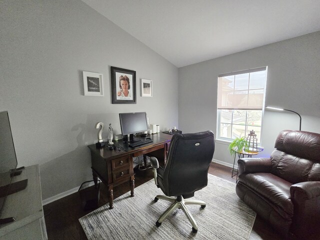 office space with vaulted ceiling, wood finished floors, and baseboards