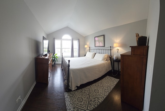 bedroom with baseboards, lofted ceiling, and dark wood-type flooring