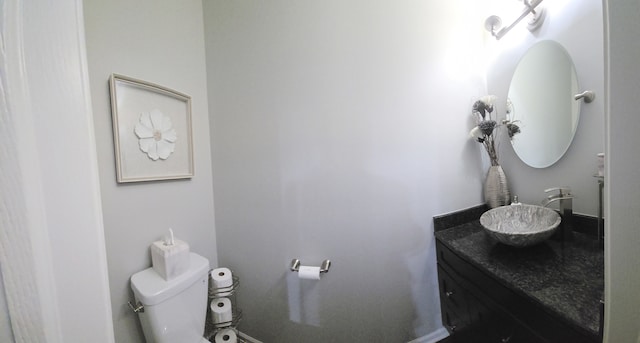 half bathroom featuring toilet and vanity