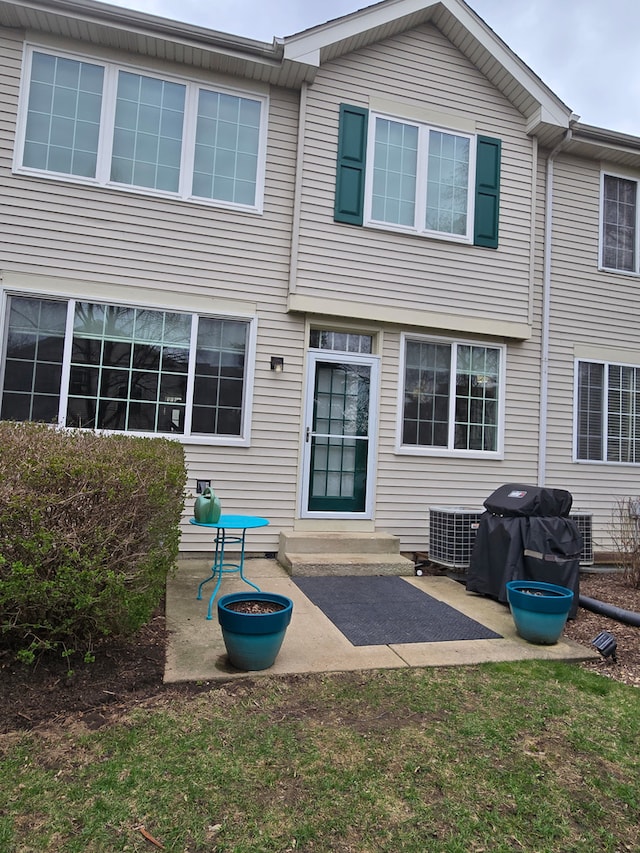 rear view of property with entry steps and a patio area