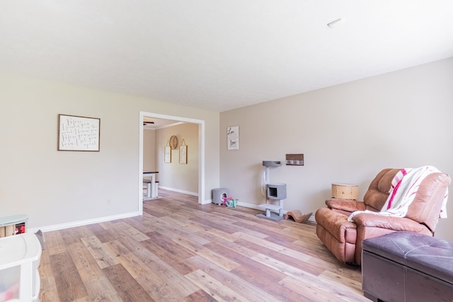 living area with baseboards and light wood-type flooring