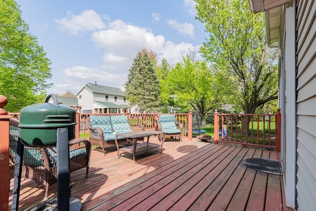 wooden deck with an outdoor living space