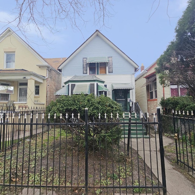 bungalow-style home featuring a fenced front yard