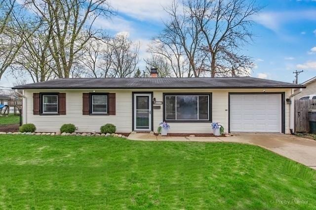 219 E Streamwood Blvd, Streamwood, IL 60107 - ranch-style home with a front lawn, fence, a chimney, concrete driveway, and an attached garage