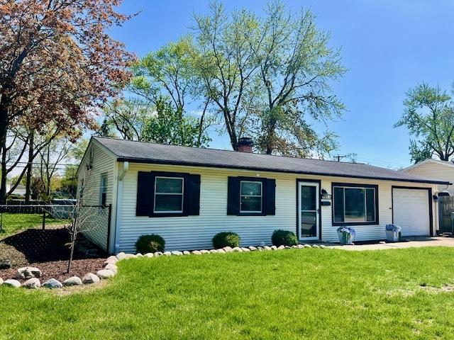 219 E Streamwood Blvd, Streamwood, IL 60107 - single story home featuring an attached garage, fence, a chimney, and a front yard