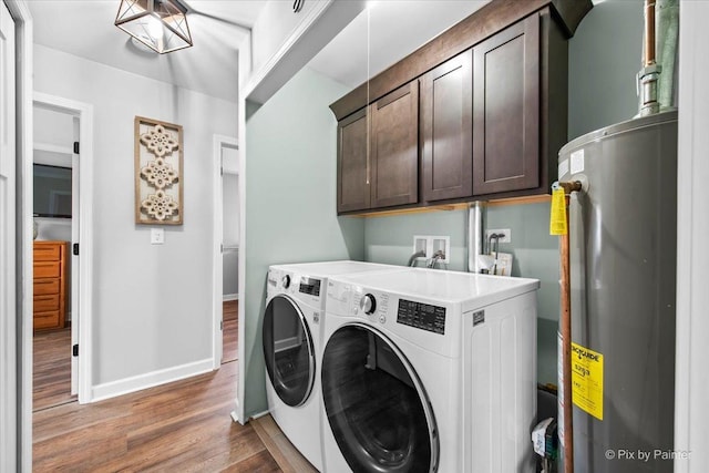 219 E Streamwood Blvd, Streamwood, IL 60107 - clothes washing area featuring washing machine and clothes dryer, cabinet space, water heater, baseboards, and wood finished floors