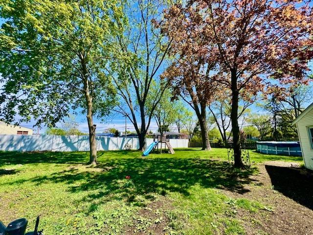 219 E Streamwood Blvd, Streamwood, IL 60107 - view of yard with a fenced backyard and a playground