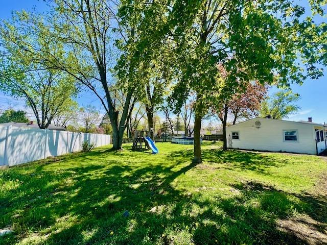 219 E Streamwood Blvd, Streamwood, IL 60107 - view of yard with a playground and a fenced backyard