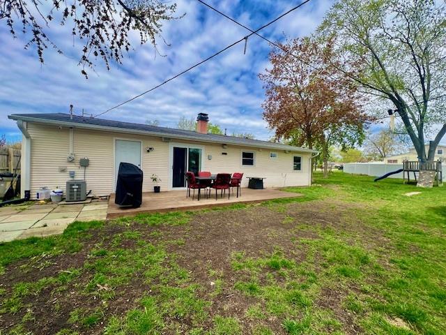 219 E Streamwood Blvd, Streamwood, IL 60107 - rear view of property with a chimney, fence, cooling unit, a playground, and a yard