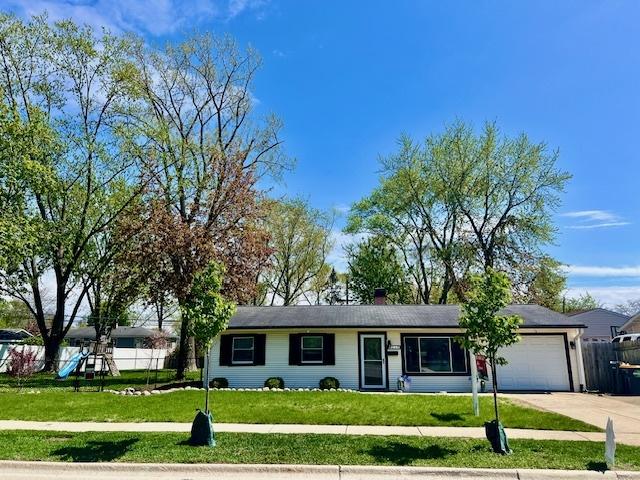 219 E Streamwood Blvd, Streamwood, IL 60107 - ranch-style home with an attached garage, fence, driveway, and a front yard