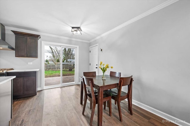 219 E Streamwood Blvd, Streamwood, IL 60107 - dining room with crown molding, baseboards, wood finished floors, and visible vents