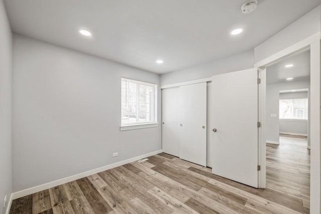 43 S Treehouse Ln, Round Lake, IL 60073 - unfurnished bedroom with recessed lighting, baseboards, wood finished floors, and a closet