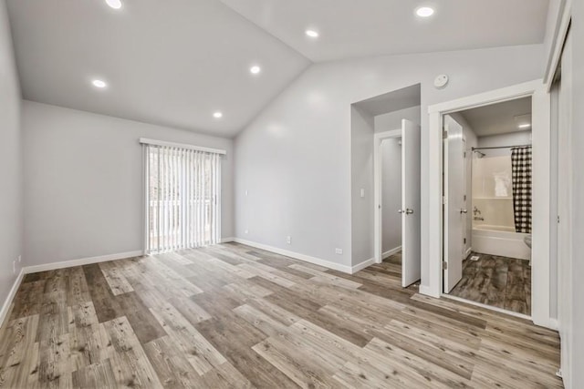 43 S Treehouse Ln, Round Lake, IL 60073 - unfurnished bedroom featuring vaulted ceiling, light wood finished floors, baseboards, and ensuite bathroom