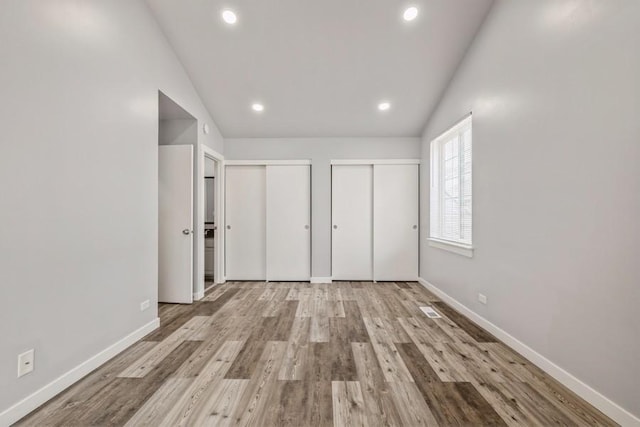 43 S Treehouse Ln, Round Lake, IL 60073 - unfurnished bedroom featuring recessed lighting, vaulted ceiling, multiple closets, and baseboards